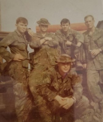 Jim Ketrow kneels in front of his Ranger team.
