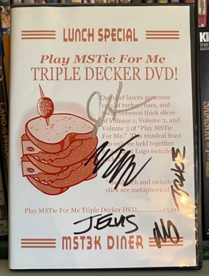 DVD of Play MSTie for Me: Triple Decker DVD!. It's a collection of musical segments from Mystery Science Theater 3000. The cover of the DVD is made to look like a menu from a diner, with it saying
