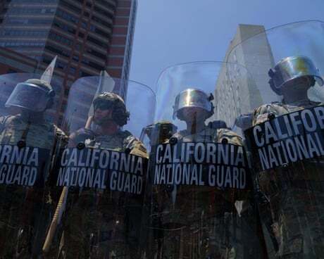 Members of the California National Guard stand behind shields