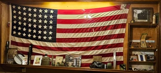 A display case featuring an American flag and a soldier's memorabilia from Operation Desert Storm