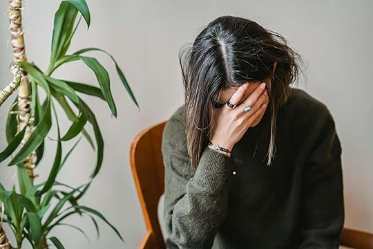 Upset woman sitting in a chair covering her face with her hand. Begin to overcome your OCPD perfectionism with the support of compassionate therapists in perfectionism treatment in Houston, TX.