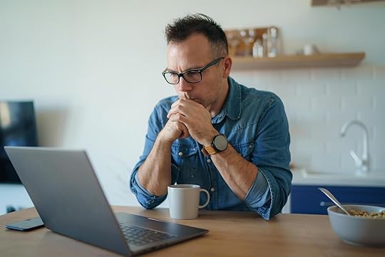 Thoughtful man sitting at a table looking at a laptop. Don't struggle on your own with perfectionism and OCPD. With the help of perfectionism treatment in Houston, TX you can learn to reduce your anxiety in positive ways.