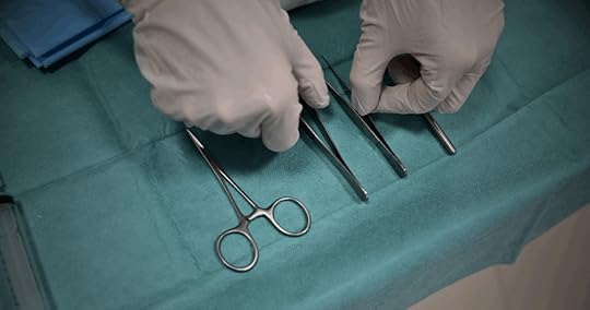 gloved hands with surgical tools