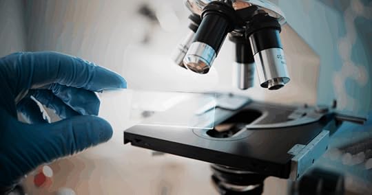 gloved hand handling microscope slide