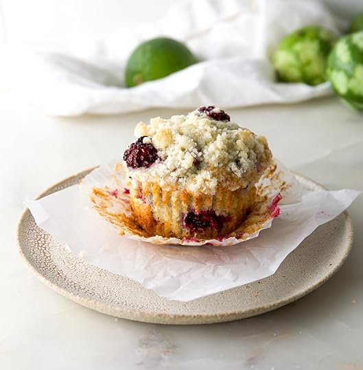 Moist berry muffin with crumb topping, perfect for drizzling with homemade lime glaze.