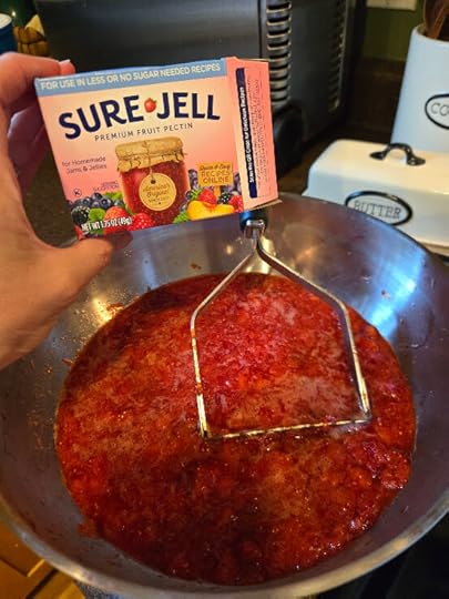 Sure Jell pectin and a bowl of crushed strawberries