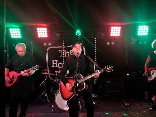 Salter Cane on stage, with Chris in full howl singing into the mic and playing guitar, flanked by Jeremy on slide bouzouki and Jessica on bass (Matt on the drums is hidden behind Chris).