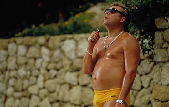 Ray Winstone smokes a cigarette in yellow swim briefs in