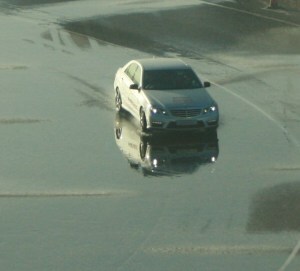 Car in water potential for hydroplaning and skids