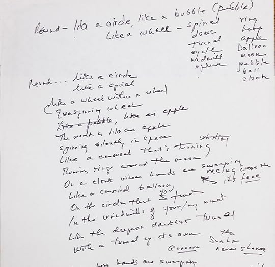 A white sheet of paper with short lines of writing and lists of words partially down the right side.