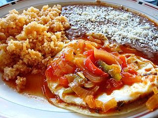 A plate of rice, beans, and huevos rancheros