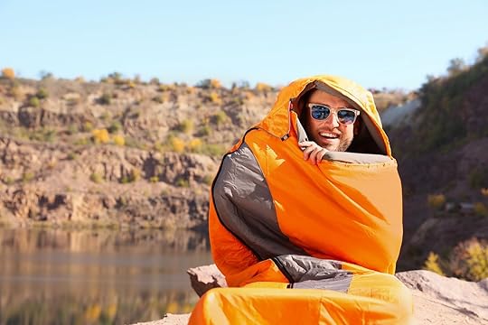 how to stay warm while camping - guy in sleeping bag