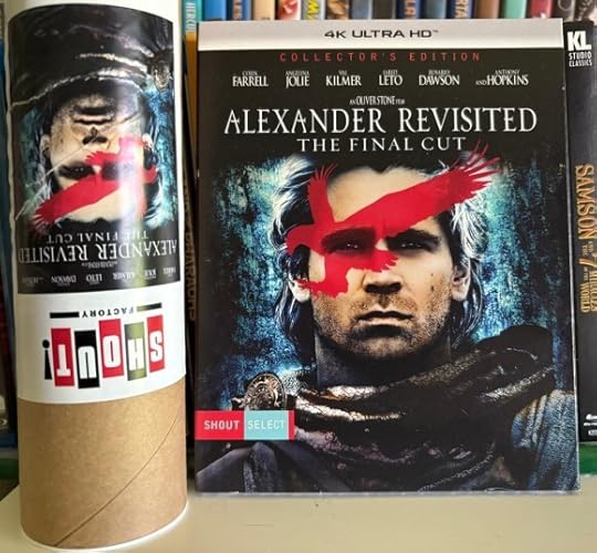 4K version of Alexander: Revisited, the Final Cut. It's a close up of Colin Farrell's face, with a red bird of prey imposed over it. Next to it is a cardboard tube with the 4K art, but upside down (it has the poster in it).