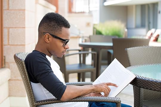 high school guy reading a book for pleasure
