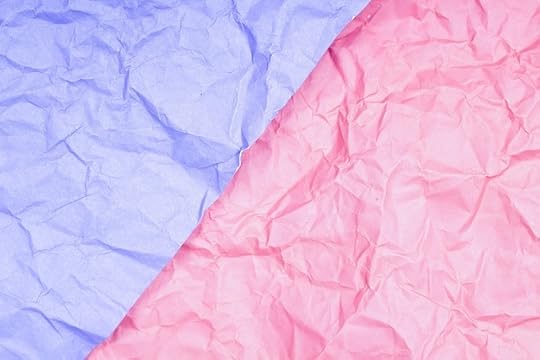 Wrinkled sheets of pale blue and pale pink tissue paper beside each other.