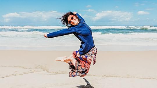 girl jumping in the air on the beach