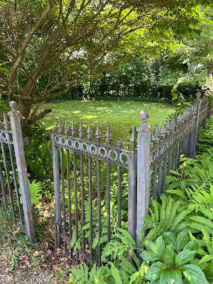 Photograph of the secret garden from ‘The Love Killings’ by Robert Ellis, Book 2 in the Detective Matt Jones thriller series, includes a wrought iron fence and gate opening to a mysterious garden where a murder occurred invoking the mood and suspense of this gripping bestselling novel, The Love Killings, by Robert Ellis.