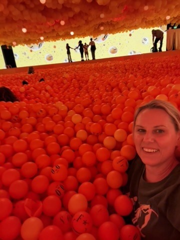 buried in orange balls at the balloon museum