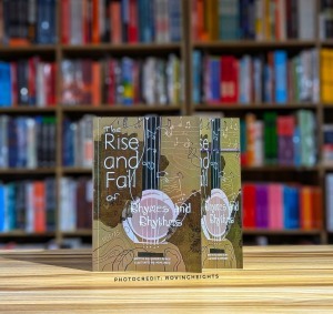 The book The rise and fall of rhythm and rhymes sitting on a table at a bookstore.