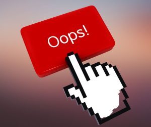white cartoon hand pointing to a red button reading Oops!