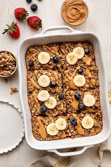 banana baked oatmeal in white casserole dish with blueberries and banana slices.