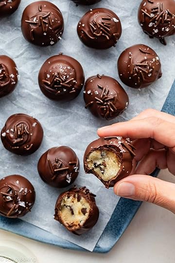 hand holding chocolate chip cookie dough truffle.