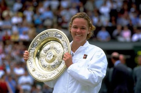 Lindsay Davenport of the United States proudly lifts the trophy after winning the Wimbledon Ladies Singles Championship Final match against Steffi...