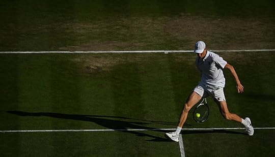 Italy's Jannik Sinner returns the ball between his legs to Spain's Carlos Alcaraz during their men's singles final tennis match on the fourteenth day...