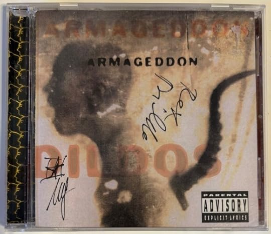 Cover is blurry - it is a profile of a person with a cord coming from their back. Sorta like Neo waking up from the matrix. In black ink it is signed 