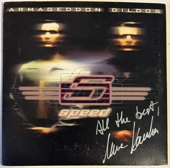 Cardboard clipcase packaging. Shows both band members, but blurred as if they are shifting left and right. In silver pen it is signed 