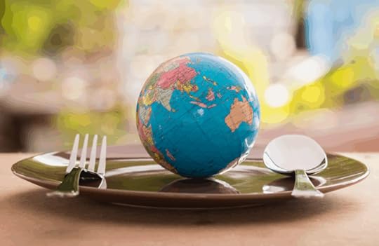 Photograph of the earth on a plate with a knife and fork to illustrate the idea of AI eating the world