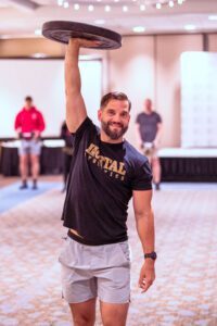 Scott Jablonka smiles as he performs a waiter walk at the Two-Brain Summit.