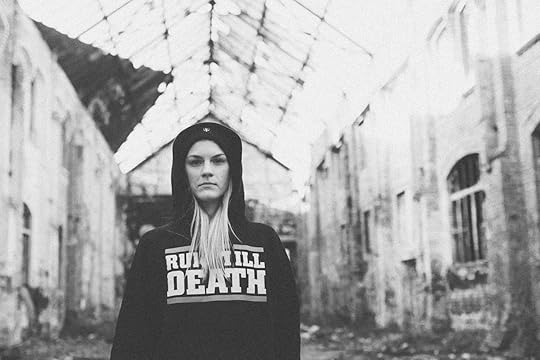 Female runner wearing a run till death hoodie