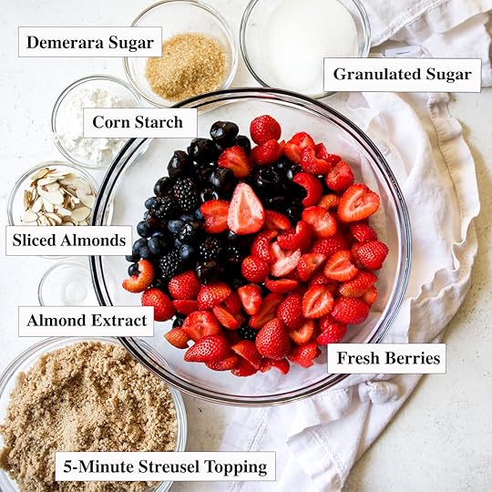 Ingredients for Mixed Berry Crumble including fresh strawberries, blueberries, blackberries, sliced almonds, Demerara sugar, granulated sugar, corn starch, almond extract, and 5-Minute Streusel Topping.