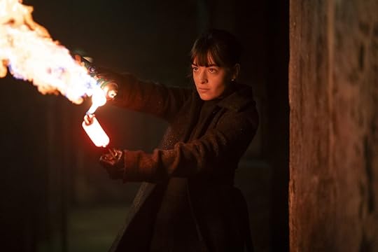 A young woman holds up a torch on Talamasca: The Secret Order