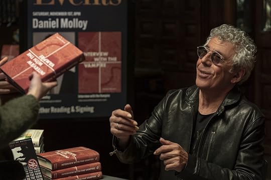 Eric Bogosian in glasses signing books on Talamasca: The Secret Order