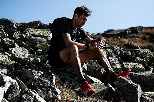 The author sitting on a stone in the mountains