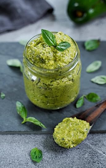 avocado basil pesto in glass jar with wooden spoon