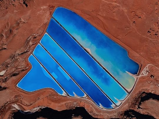 Vibrant blue ponds against red earth.