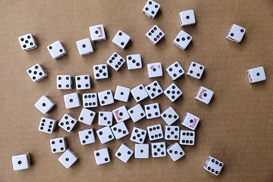 white and black dice on brown wooden table