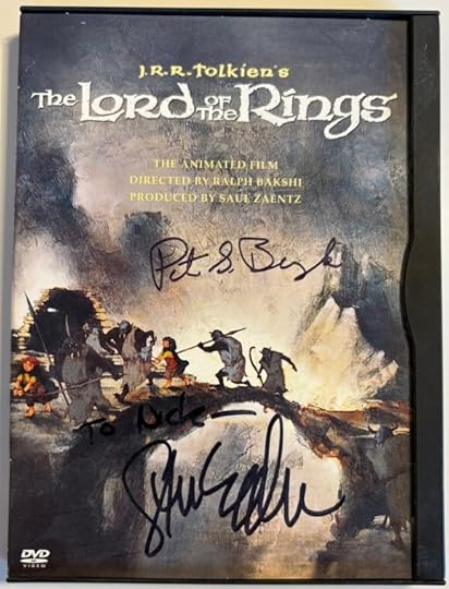 Snap case DVD of Lord of the Rings. Cover show the hobbits crossings a narrow bridge. with orcs and spears escorting them. In black ink it is signed 