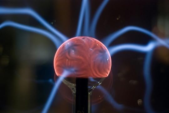 A quantum manifestation plasma globe with electric blue tendrils radiating from a glowing red core.