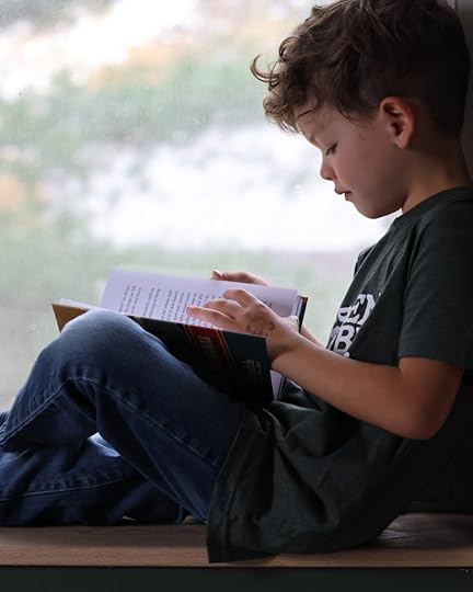 Boy reading Green Ember, Reluctant Reader
