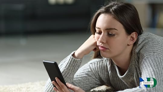 A teen girl looking at her phone.