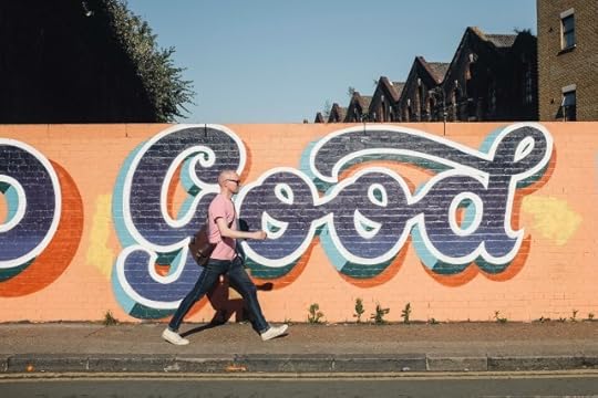 A man walking past a wall with “Good” graffiti across it. You’re allowed moments of good amid this bad.