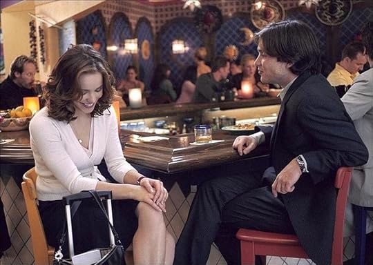 Rachel McAdams and Cillian Murphy sitting at a bar chatting and smiling.