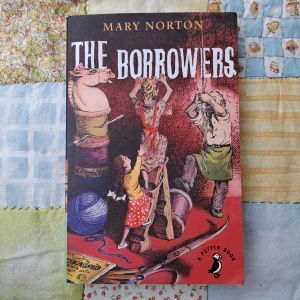 cover of The Borrowers by Mary Norton on a colourful patchwork quilt