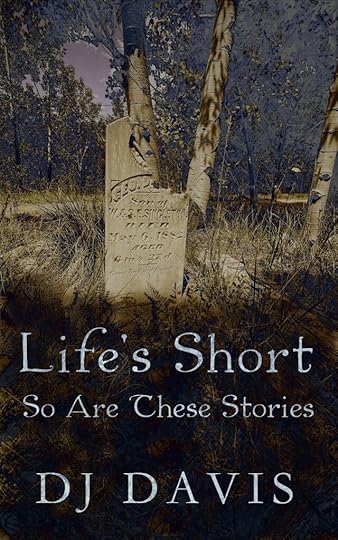 A broken headstone in a graveyard full of grass and aspen trees.