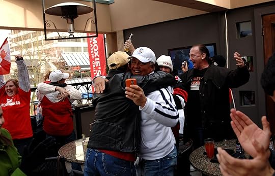 people hugging at sports bar in vancouver 