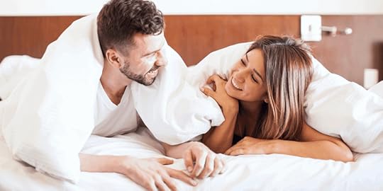 Married couple cuddling in bed, illustrating intimacy and emotional connection in marriage